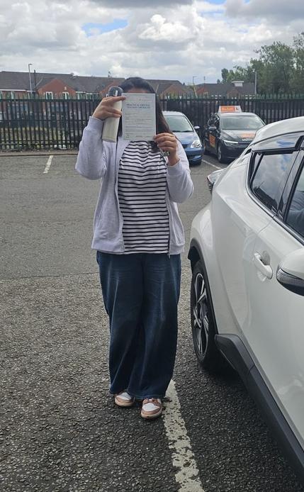 Newly passed driver beside a DriveCrest dual-control tuition car