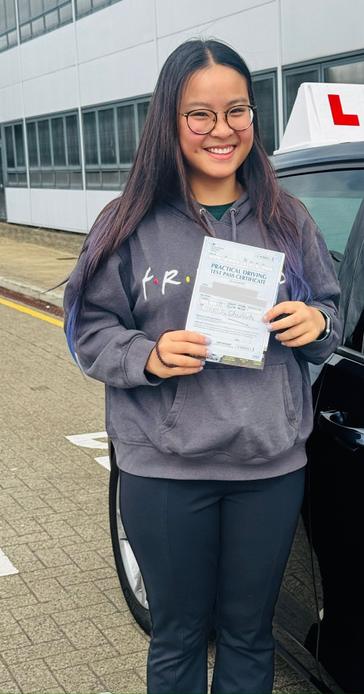 Student of a DriveCrest driving instructor holding their pass certificate