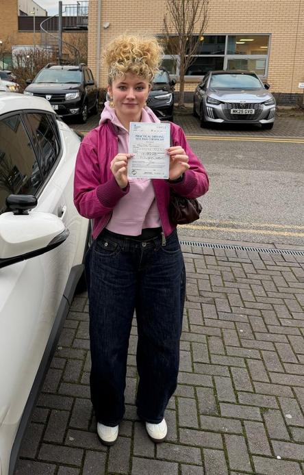 Newly passed driver beside a DriveCrest dual-control tuition car