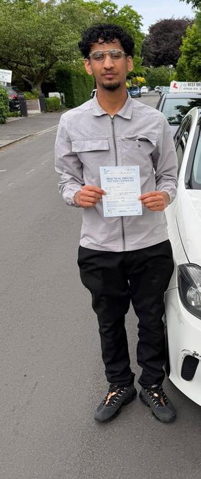 Newly passed driver beside a DriveCrest dual-control tuition car