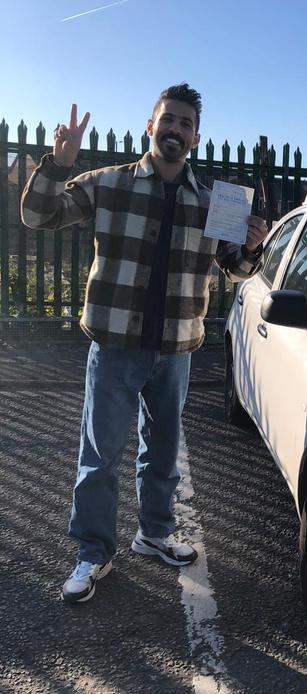 Newly passed driver beside a DriveCrest dual-control tuition car