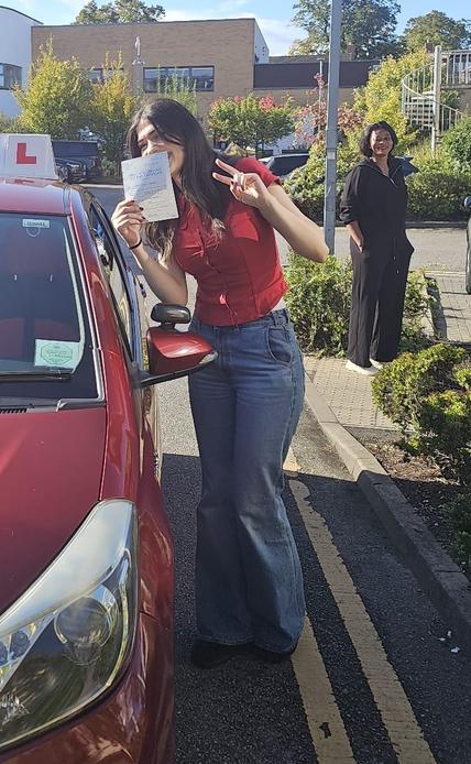 Student celebrating after driving lessons in Greater Manchester
